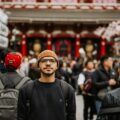 A man poses in front of a temple.